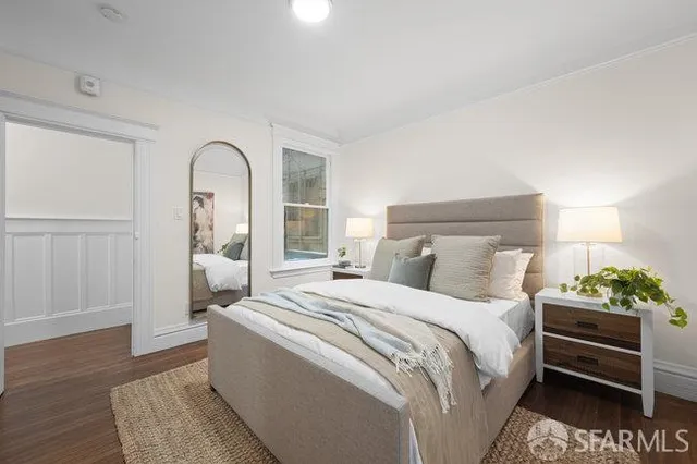 a bedroom with a bed and a potted plant