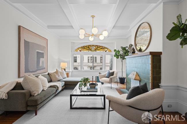 1108-1112 Pine Street San Francisco, CA 94109 - Photo 6 of 53 a living room with furniture a fireplace and a chandelier