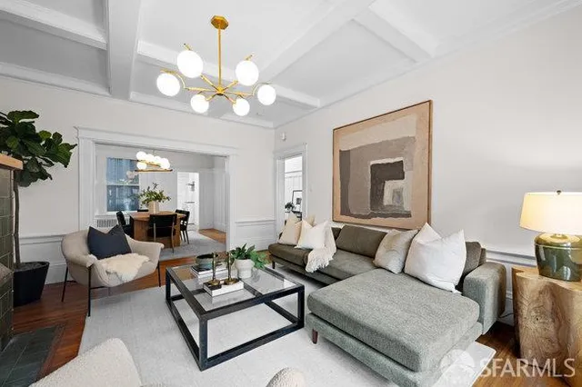 a living room with furniture chandelier and a chandelier