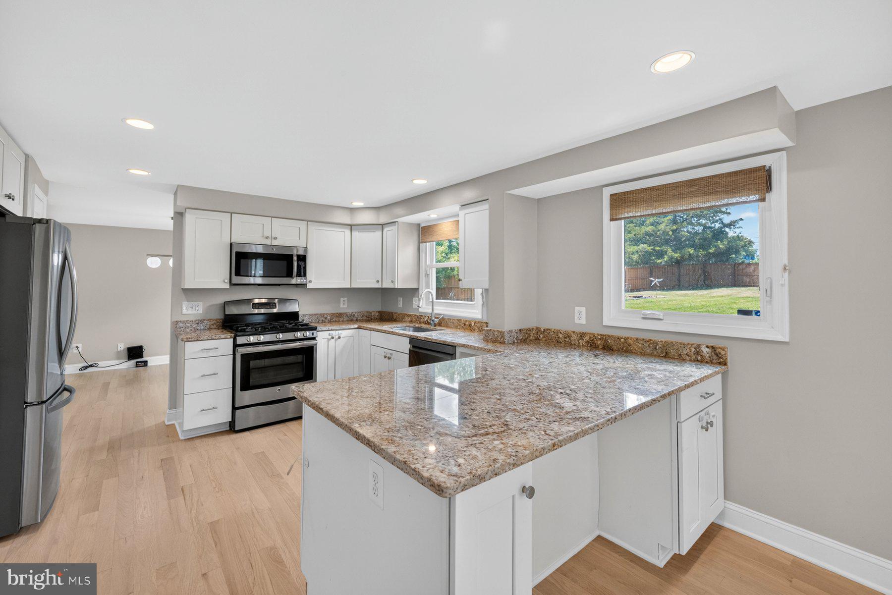 7518 Candytuft Court Springfield, VA 22153 - Photo 9 of 47 a kitchen with stainless steel appliances granite countertop a sink stove and refrigerator