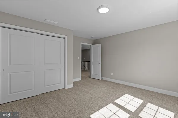 a view of a hallway with wooden floor and entryway
