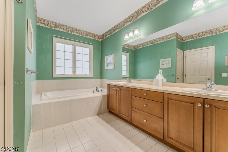 43 Falcon Way Washington, NJ 07882 - Photo 22 of 29 a spacious bathroom with a tub sink double vanity and a mirror
