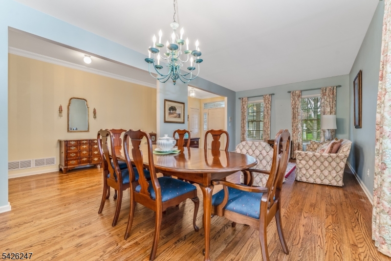 43 Falcon Way Washington, NJ 07882 - Photo 9 of 29 a view of a dining room with furniture a chandelier and wooden floor