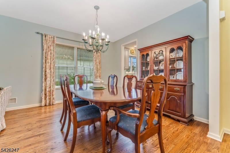 43 Falcon Way Washington, NJ 07882 - Photo 10 of 29 a view of a dining room with furniture a chandelier and wooden floor