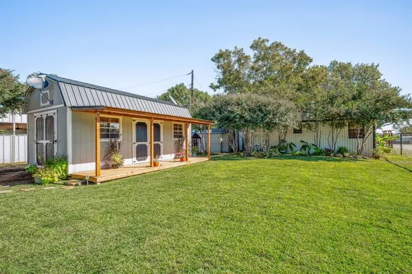 a view of a house with a yard and sitting area