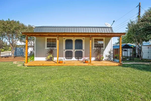 a view of a house with a yard and sitting area