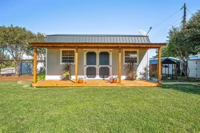 a view of a house with a yard and sitting area