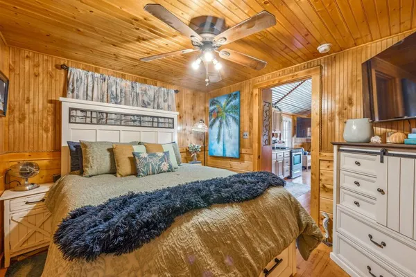 a bedroom with a large bed and a chandelier