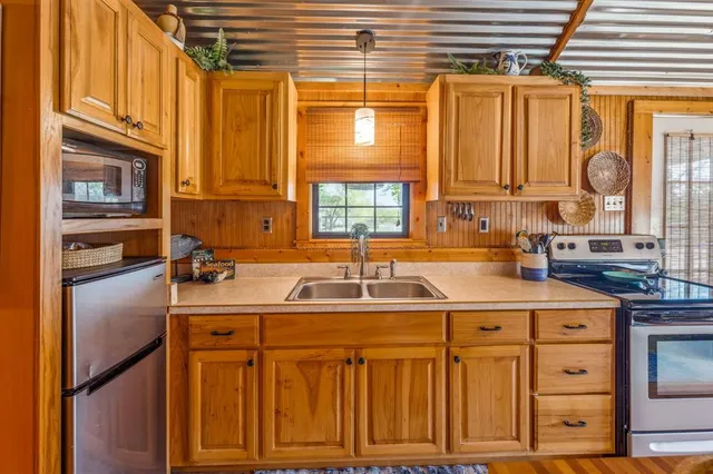 a kitchen with stainless steel appliances granite countertop a sink and cabinets