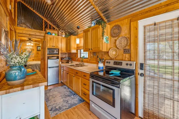 a kitchen with stainless steel appliances granite countertop a stove a sink and a refrigerator