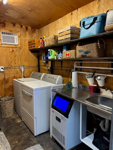 a utility room with stainless steel appliances granite countertop a stove and a sink