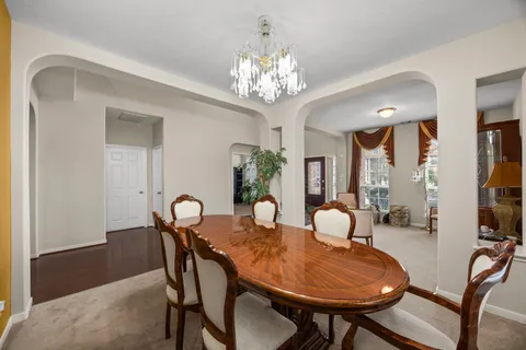a view of a dining room with furniture and chandelier