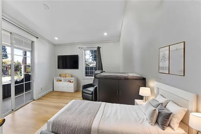 a bedroom with a bed and a flat screen tv