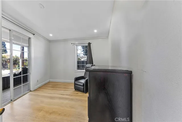 a view of a workspace with furniture and a bookshelf