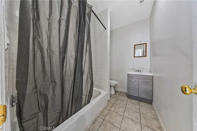 a spacious bedroom with a bed and a walk in closet