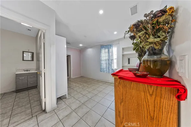 a view of a hallway with wooden floor and closet area