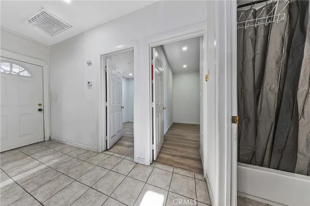 a large white kitchen with a stove a sink dishwasher and a refrigerator