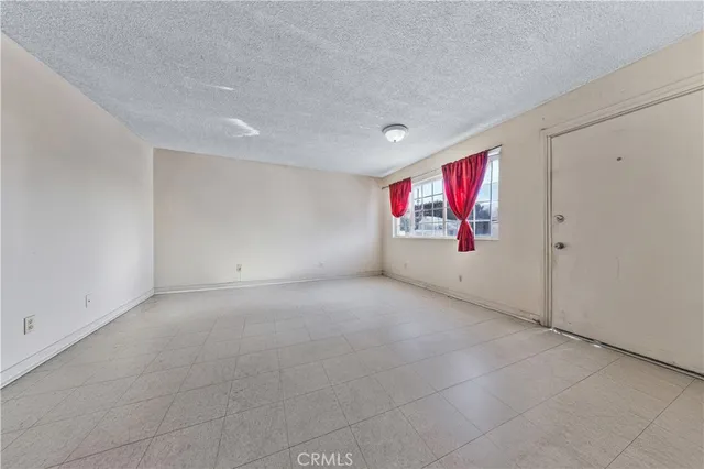 a kitchen with granite countertop white cabinets and stainless steel appliances