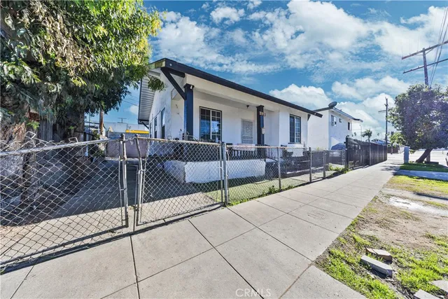 a view of a house with backyard and a tree