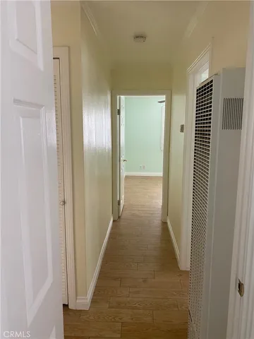 a view of a hallway with wooden floor