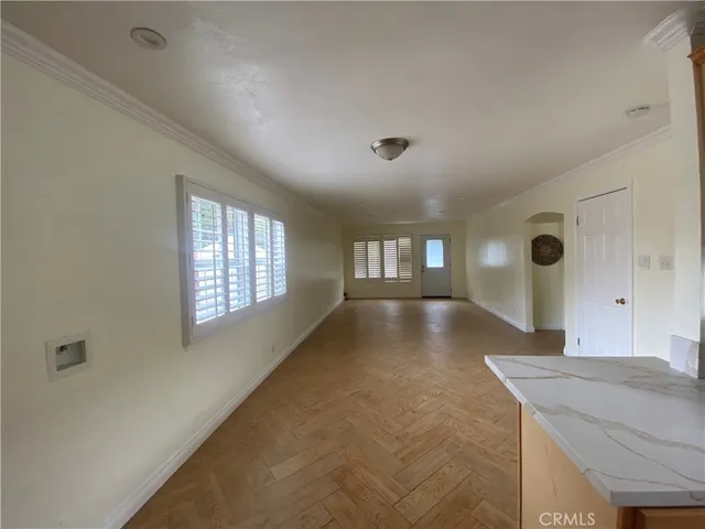 a view of a room window and wooden floor