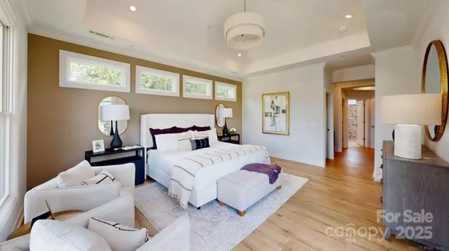a bedroom with furniture and a wooden floor