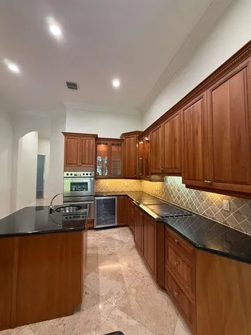 a kitchen with stainless steel appliances granite countertop a sink counter space and cabinets