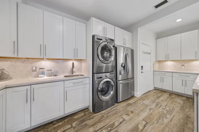a utility room with sink dryer and washer