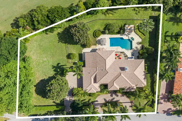an aerial view of a house with a yard