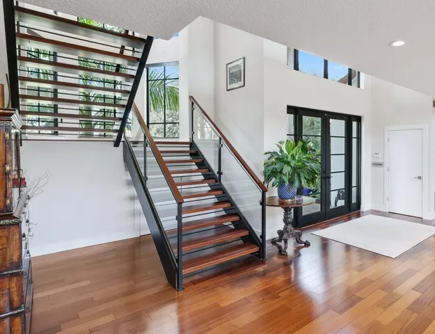 a view of entryway with wooden floor and front door