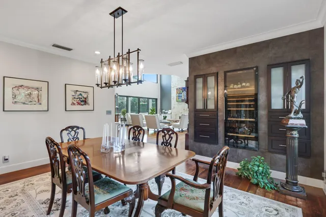 a view of a dining room with furniture and chandelier