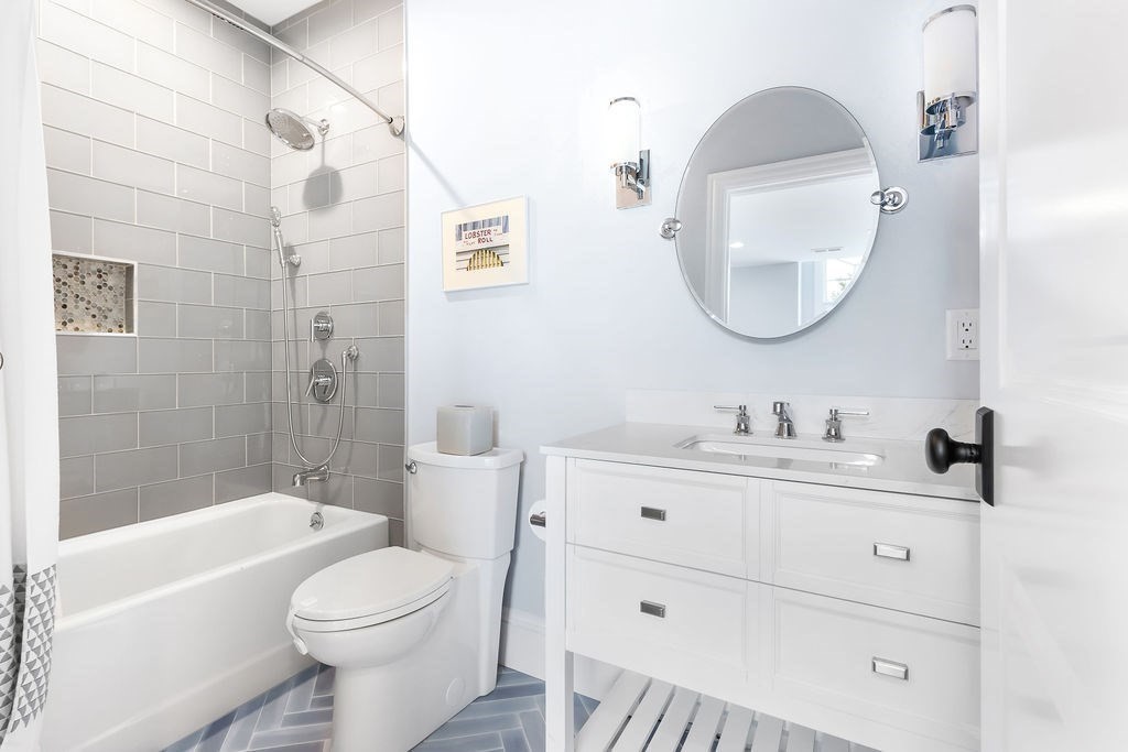 16 Grace Road Newton, MA 02459 - Photo 19 of 36 a bathroom with a toilet a sink a tub and mirror