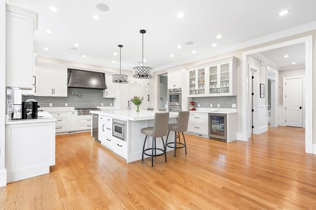 16 Grace Road Newton, MA 02459 - Photo 2 of 36 a kitchen with stainless steel appliances granite countertop a stove top oven a sink dishwasher a refrigerator and a dining table with wooden floor