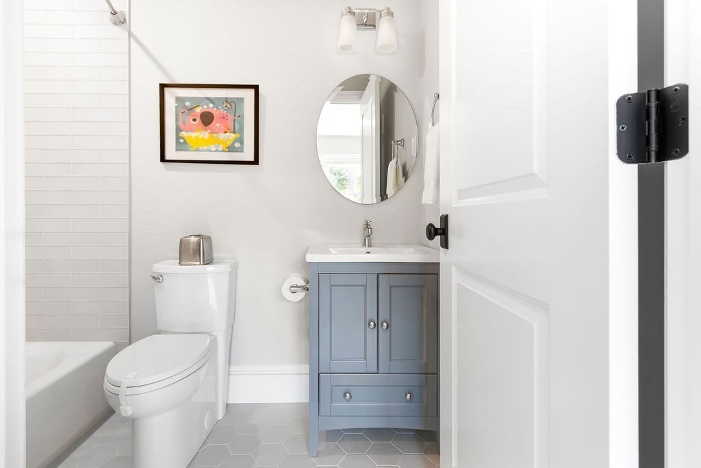 16 Grace Road Newton, MA 02459 - Photo 21 of 36 a bathroom with a toilet a sink and mirror