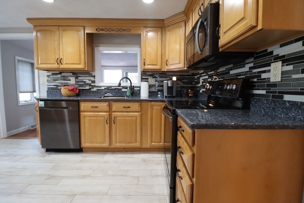 31 Longview Way Peabody, MA 01960 - Photo 11 of 42 a kitchen with stainless steel appliances granite countertop a sink a stove and a microwave