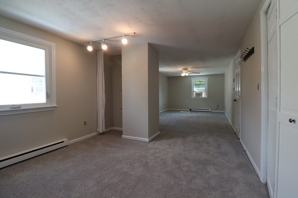 31 Longview Way Peabody, MA 01960 - Photo 22 of 42 an empty room with windows and entrance to other room