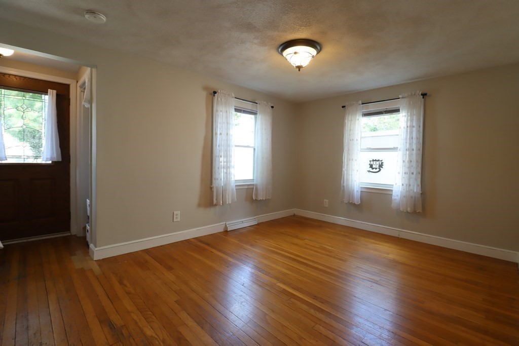 31 Longview Way Peabody, MA 01960 - Photo 10 of 42 an empty room with wooden floor and windows