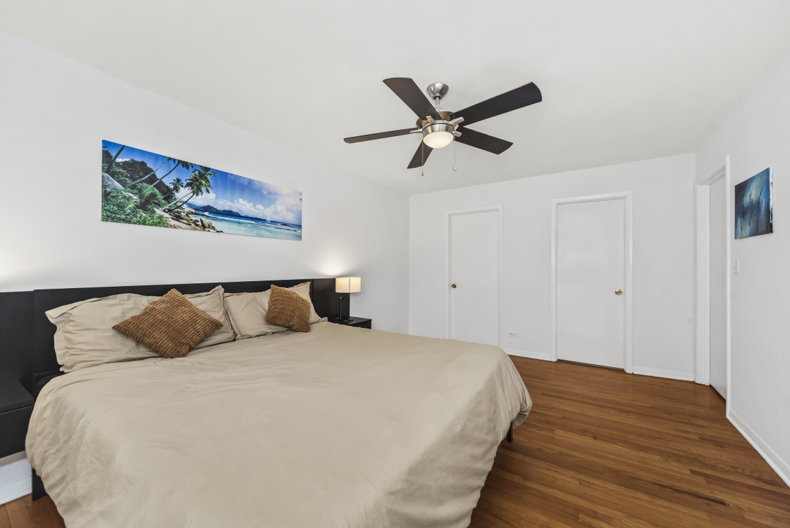 2141 Ridge Avenue, Unit 2B Evanston, IL 60201 - Photo 11 of 17 a large bed sitting in a bedroom and a chandelier