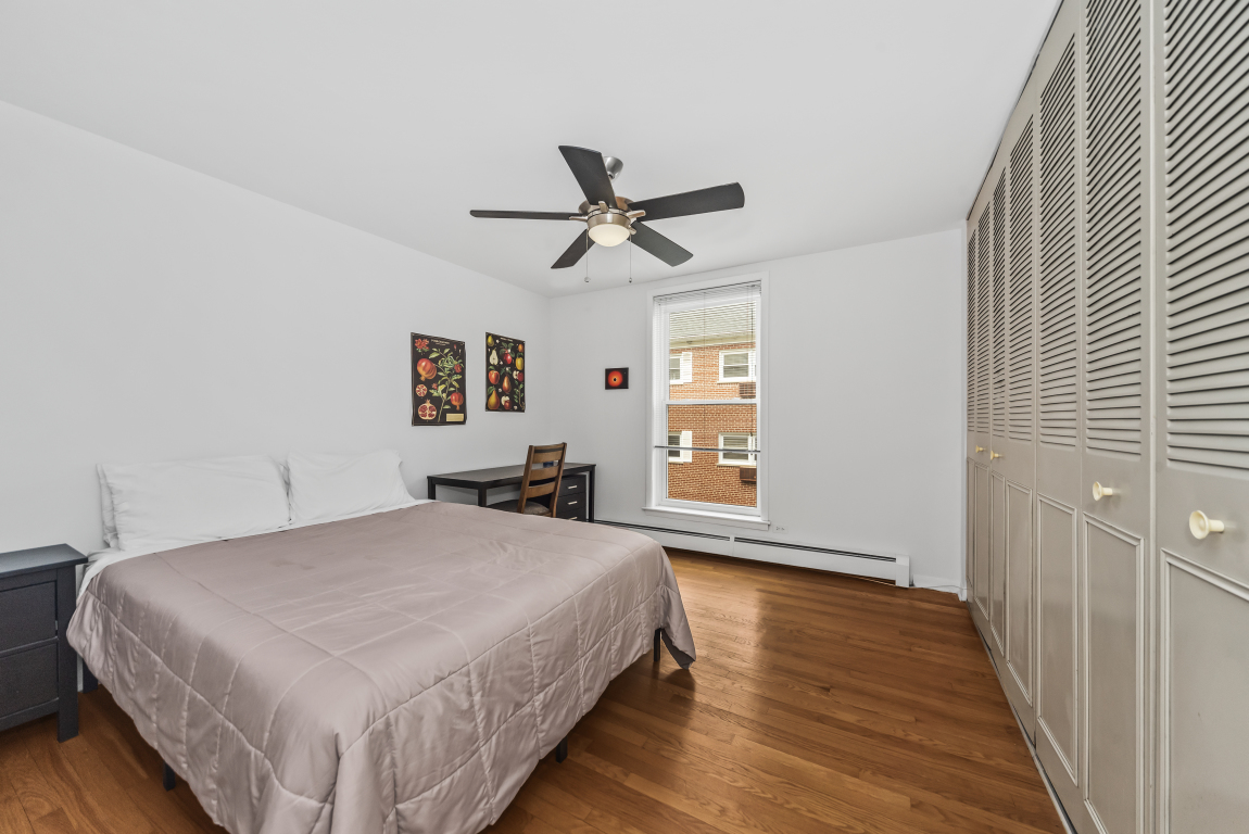 2141 Ridge Avenue, Unit 2B Evanston, IL 60201 - Photo 13 of 17 a spacious bedroom with a bed and a chandelier