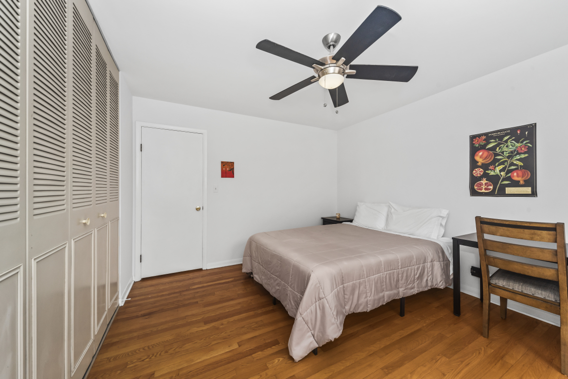 2141 Ridge Avenue, Unit 2B Evanston, IL 60201 - Photo 14 of 17 a bedroom with a bed and a chandelier