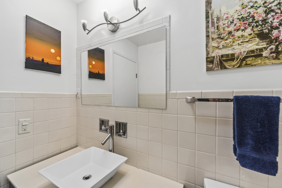 2141 Ridge Avenue, Unit 2B Evanston, IL 60201 - Photo 16 of 17 a bathroom with a sink a toilet and mirror