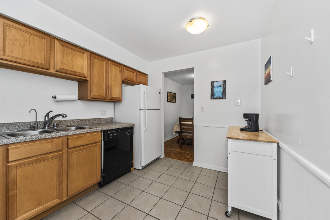 2141 Ridge Avenue, Unit 2B Evanston, IL 60201 - Photo 9 of 17 a kitchen with stainless steel appliances granite countertop a refrigerator sink and stove
