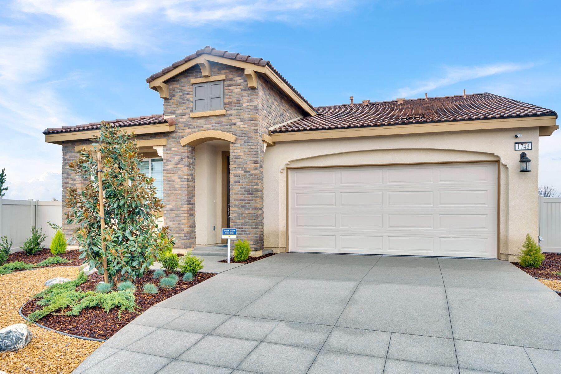 1748 East Holguin Street Lancaster, CA 93535 - Photo 1 of 20 a front view of a house with potted plants