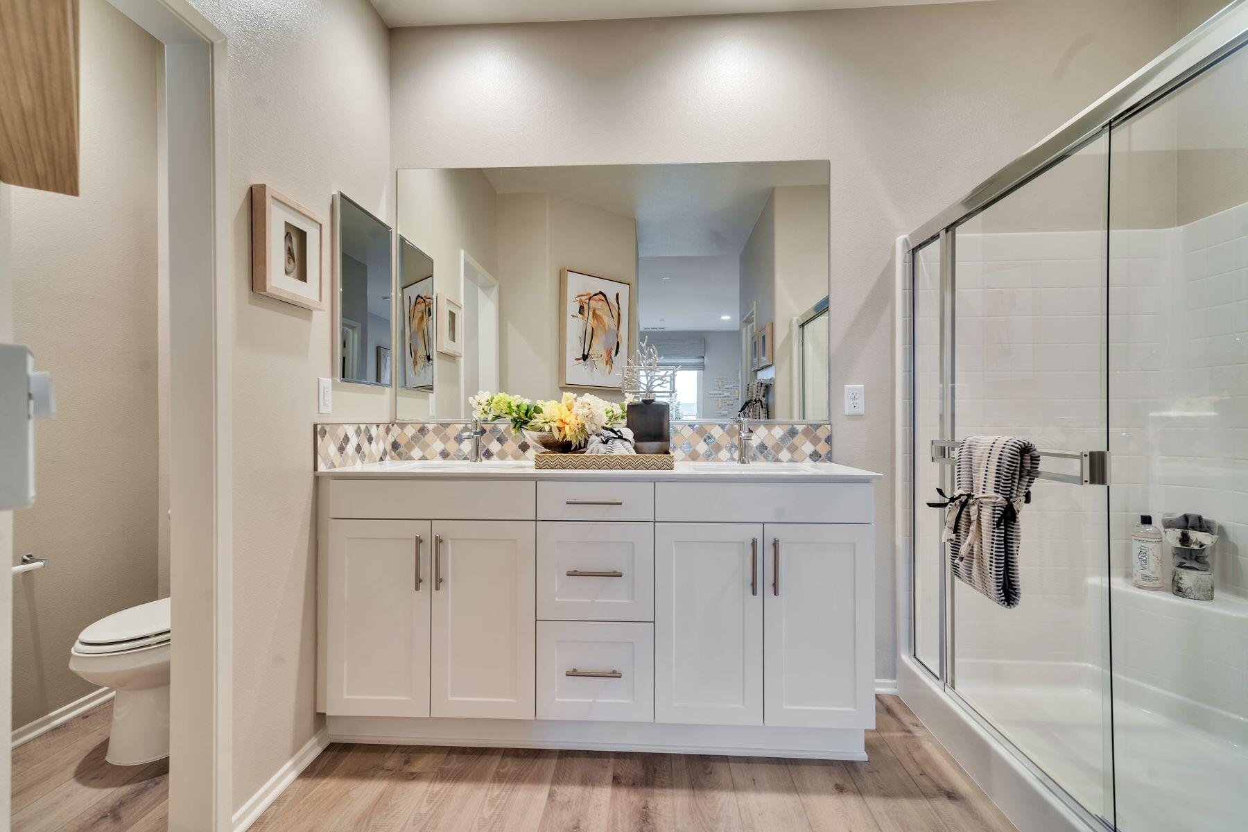 1748 East Holguin Street Lancaster, CA 93535 - Photo 11 of 20 a bathroom with a sink a toilet and shower