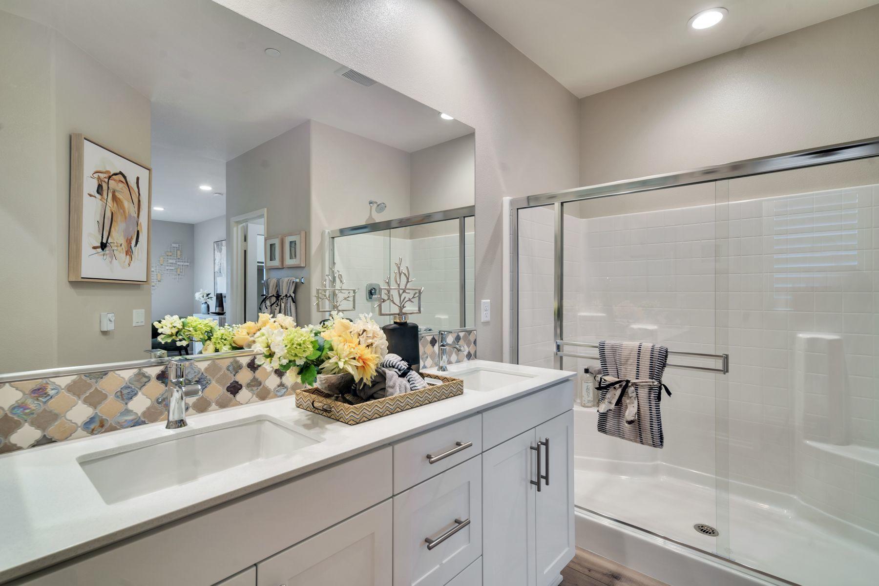 1748 East Holguin Street Lancaster, CA 93535 - Photo 12 of 20 a bathroom with a double vanity sink and mirror