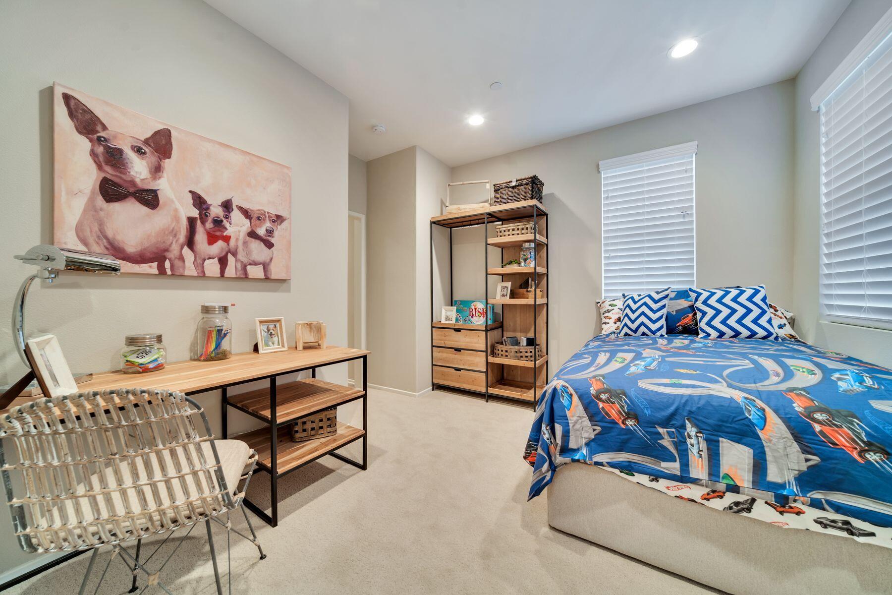 1748 East Holguin Street Lancaster, CA 93535 - Photo 16 of 20 a bedroom with furniture and a book shelf