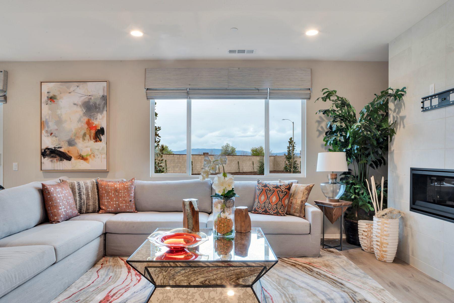 1748 East Holguin Street Lancaster, CA 93535 - Photo 8 of 20 a living room with furniture and a large window