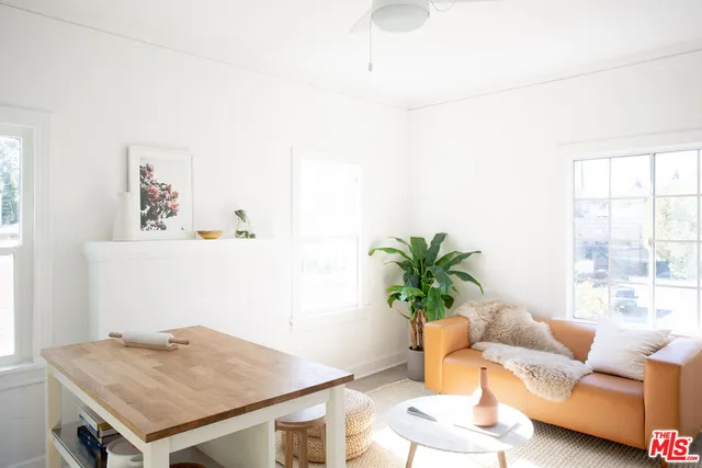 a white cabinet with a vase of flowers on it