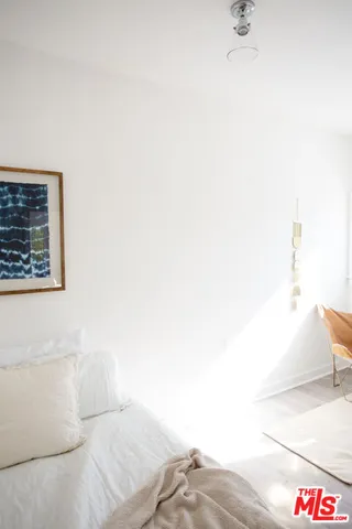 a bedroom with a bed and a night stand