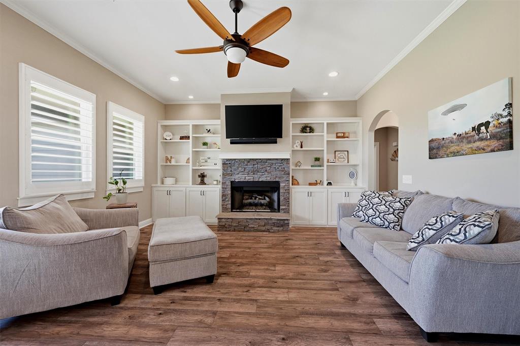 662 Preakness Place Road Van Alstyne, TX 75495 - Photo 7 of 39 a living room with furniture a flat screen tv and a fireplace